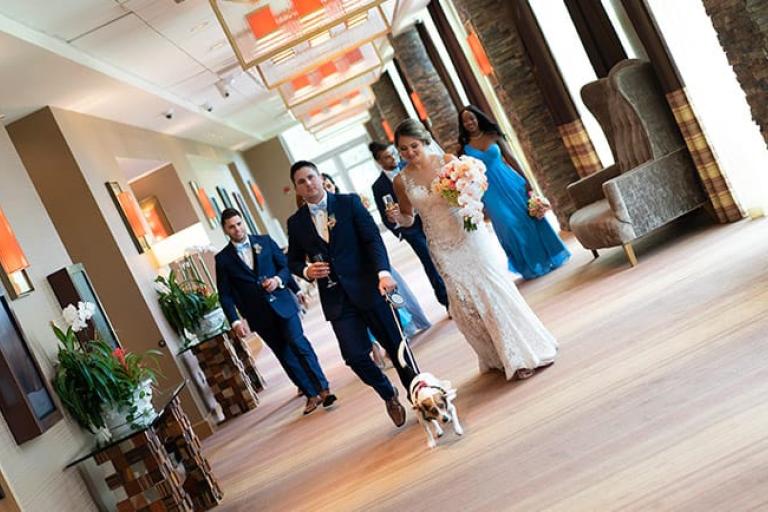 A wedding party walks down the halls of Wind Creek Atmore